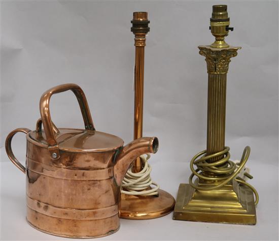 A brass table lamp, a copper table lamp and a watering can